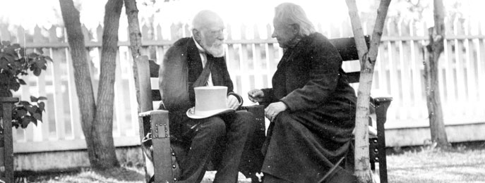 Lord Stathcona and Father Albert Lacombe meeting amidst young maple trees in Hardisty’s garden in 1909.