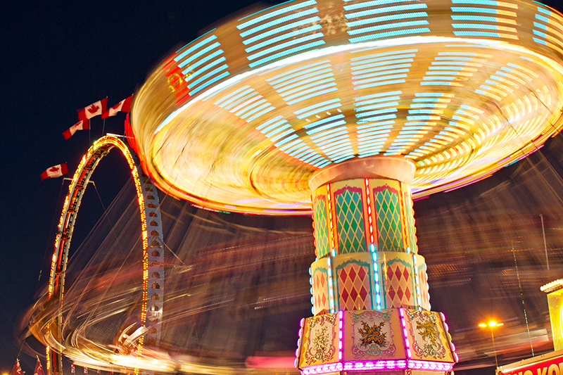 in motion view of swings ride in the dark