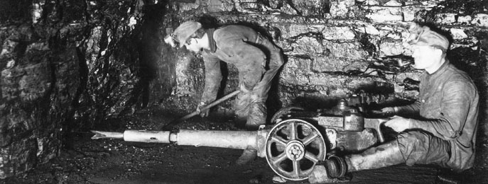 Miners drilling underground.