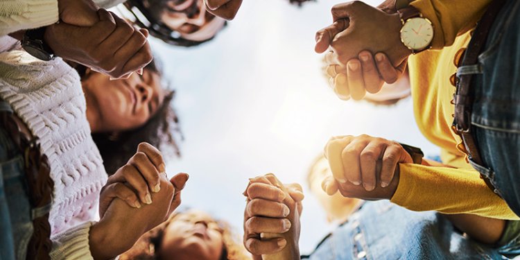 persons joining hands in a circle