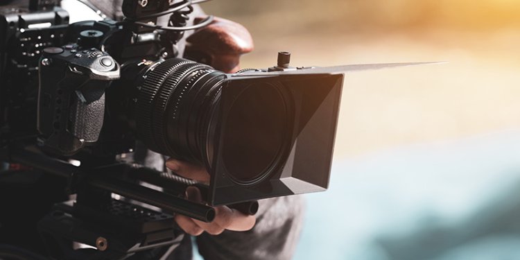 cameraman filming with camera