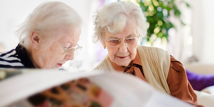 2 seniors reading newspaper