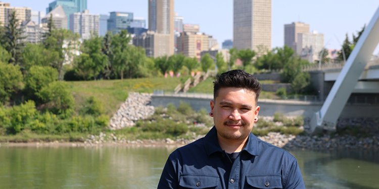 indigenous persons standing in front of nature backdrop or North Saskatchewan River