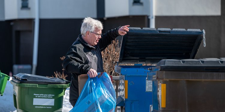 man at condo bin