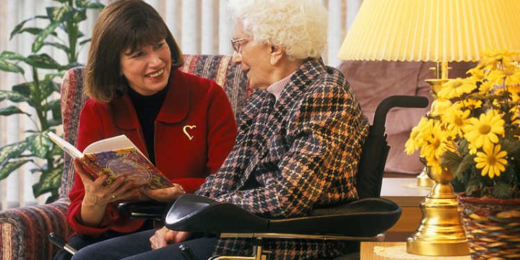 person sitting and speaking to senior