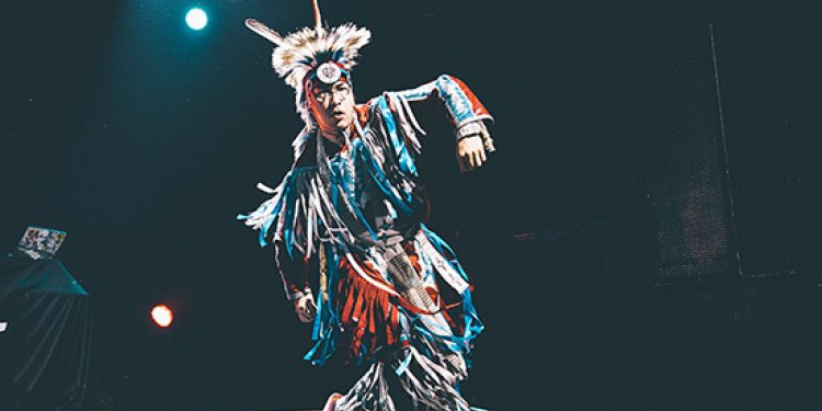 person in indigenous headgear and clothing