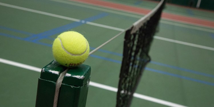 Tennis ball on net post