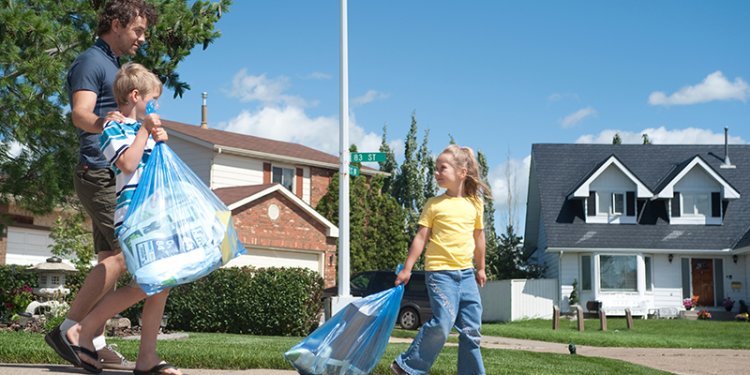 family with blue recycling bags