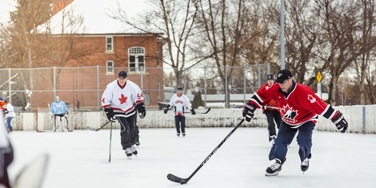 people playing ice hockey on outdoor rink