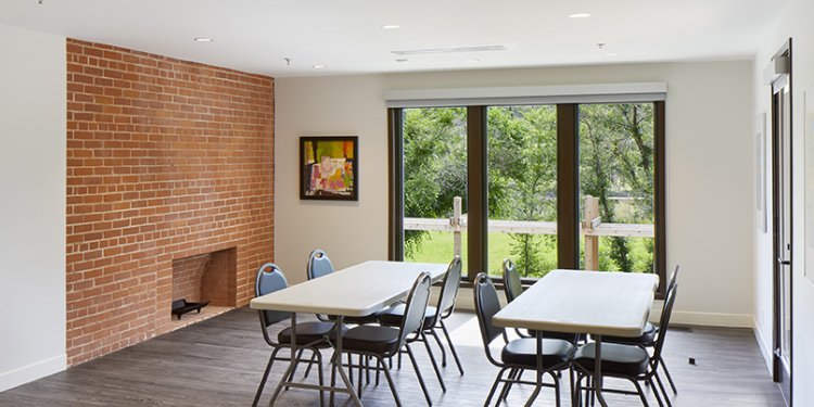 second floor room with rectangular tables with four chairs