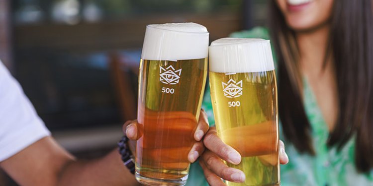 two hands holding beers