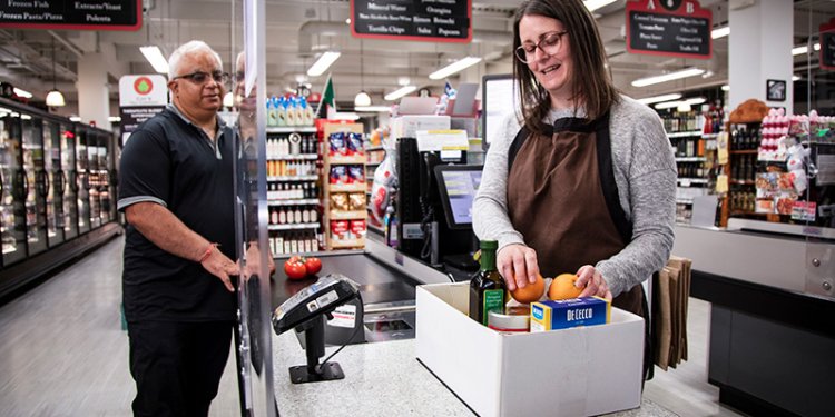 person packing box in supermarket