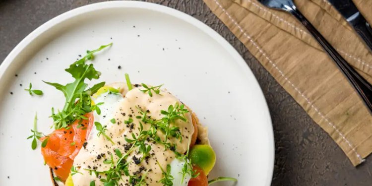 An egg dish on a plate with cutlery