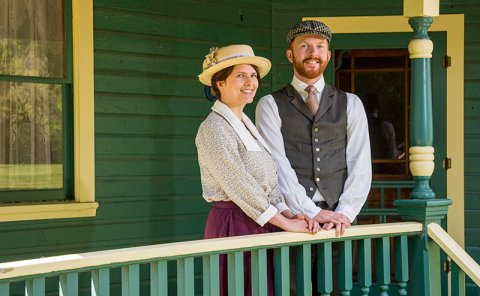 persons standing outside historical house