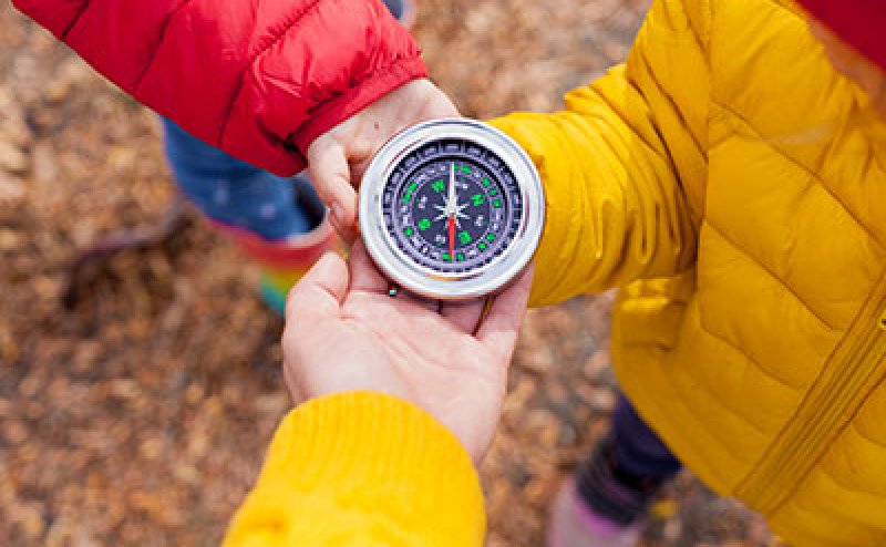 person holding compass