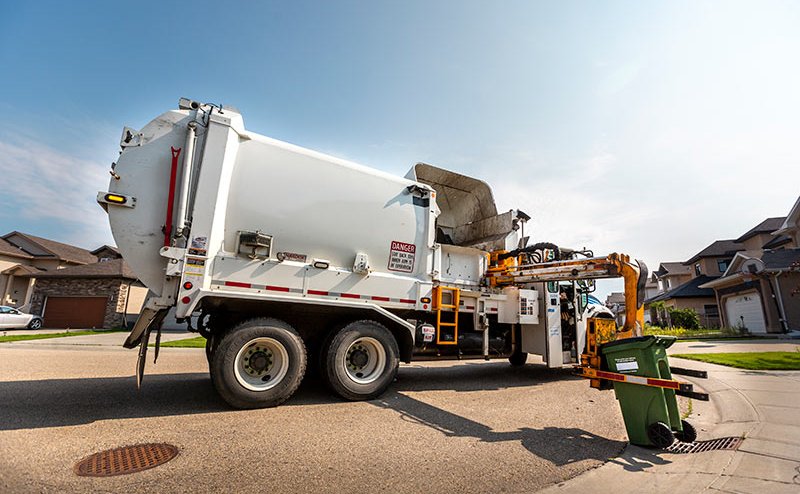 garbage truck picking up garbage cart