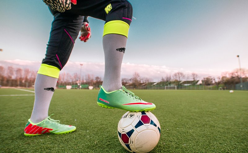 player with foot on soccer ball