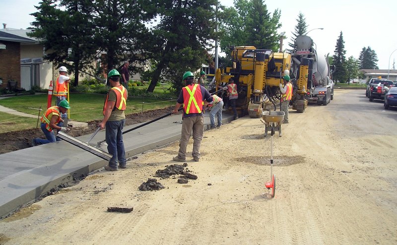 Workers reconstructing a sidewalk
