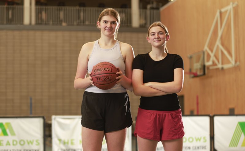 two women with one holding a basketball