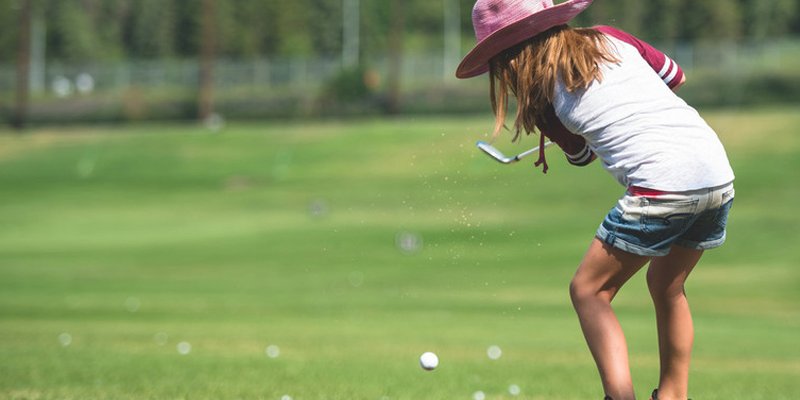 child swinging golf club