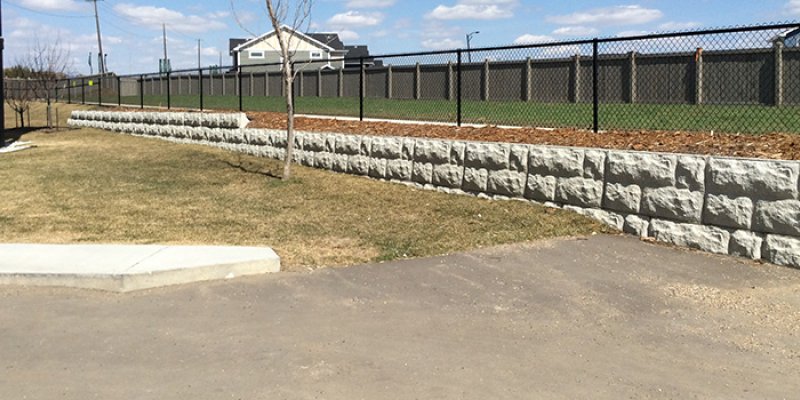Graded driveway next to a retaining wall