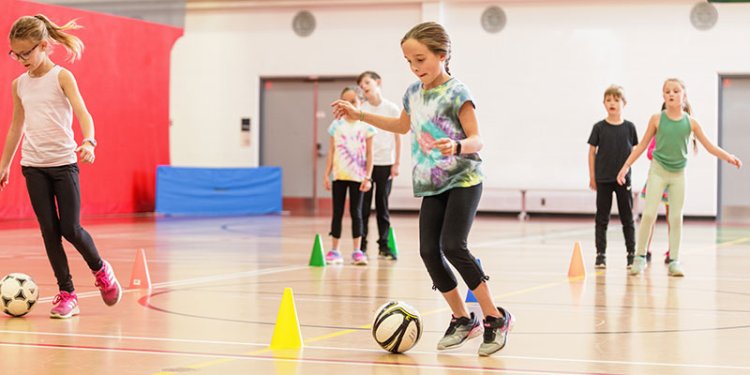 kids playing footie in gym