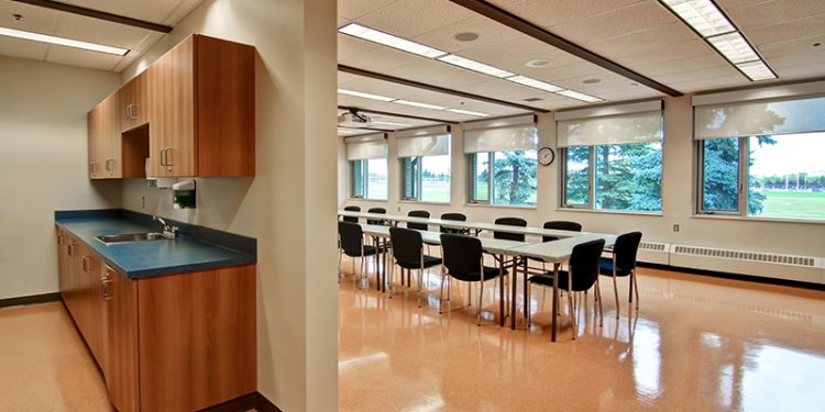 kitchen and adjoining room with a table and chairs