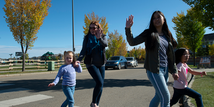 parents crossing the road on crosswalk with kids