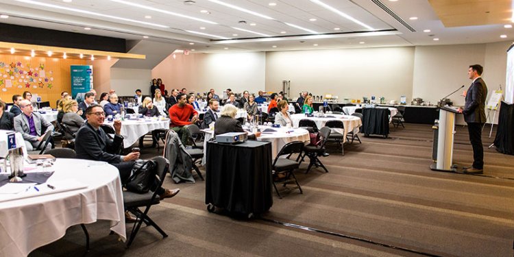 persons in ballroom attending meeting