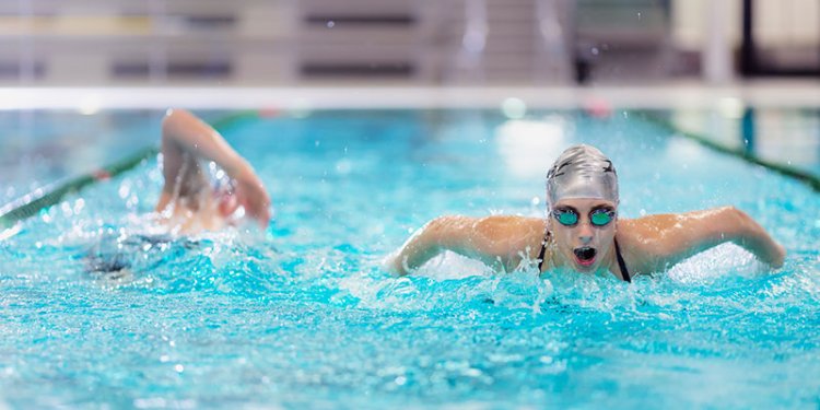 persons swimming in lane pool