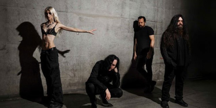 four persons standing beside a wall