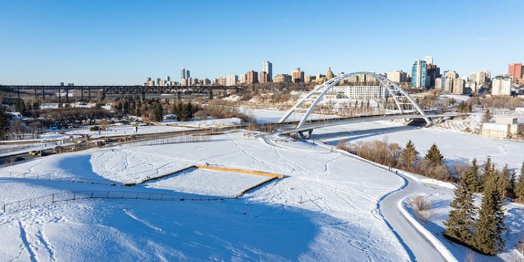 park and trails in winter with the Walterdale Bridge in the background