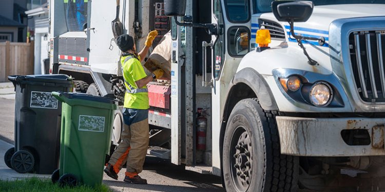 waste collector beside truck
