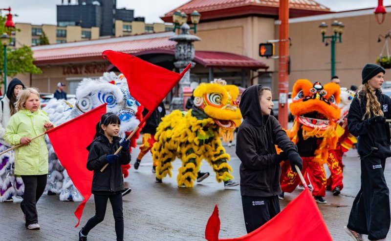 People celebrating at the Dragon Festival parade.