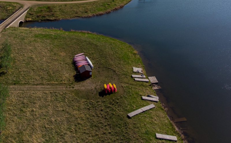 river with canoes on grassy shore