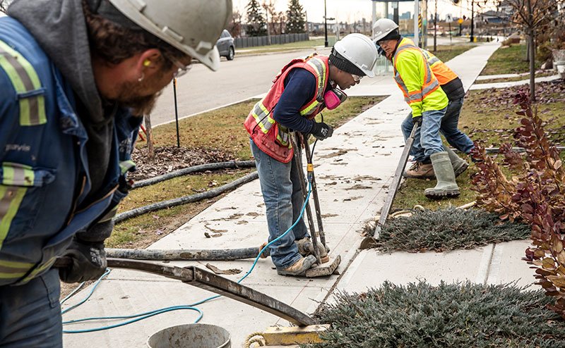 persons working on sidewalk construction