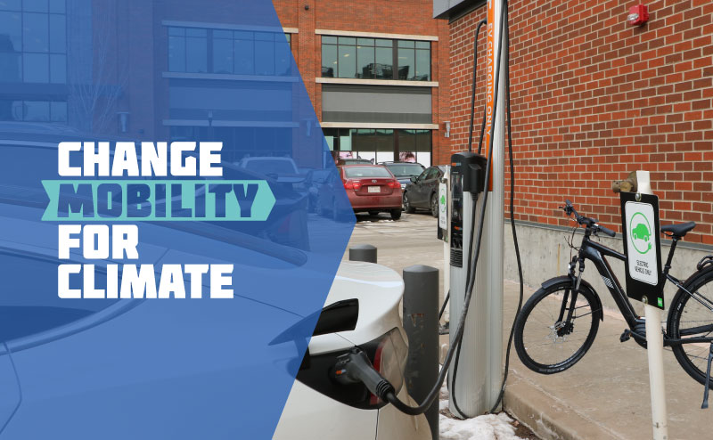 Change Mobility For Climate workdmark with electric vehicle, charger and e-bike in background